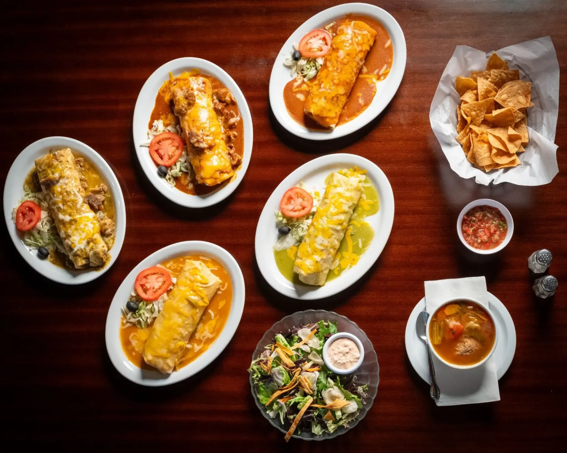 Assortment of authentic Mexican burritos and soup on a Fresno restaurant table