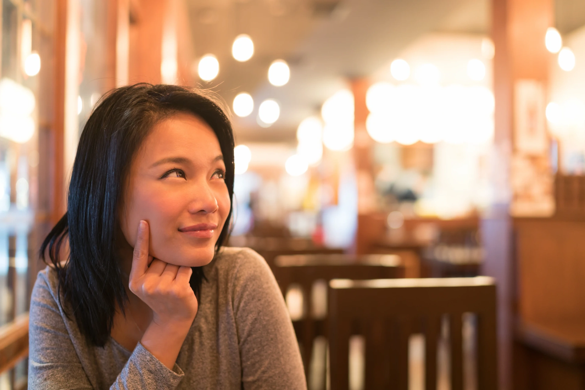 Diner thinking about what Mexican food to order at a warmly lit restaurant
